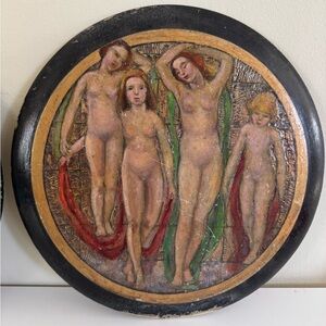 A group of four Antique impressionistic paintings on a solid wood round .